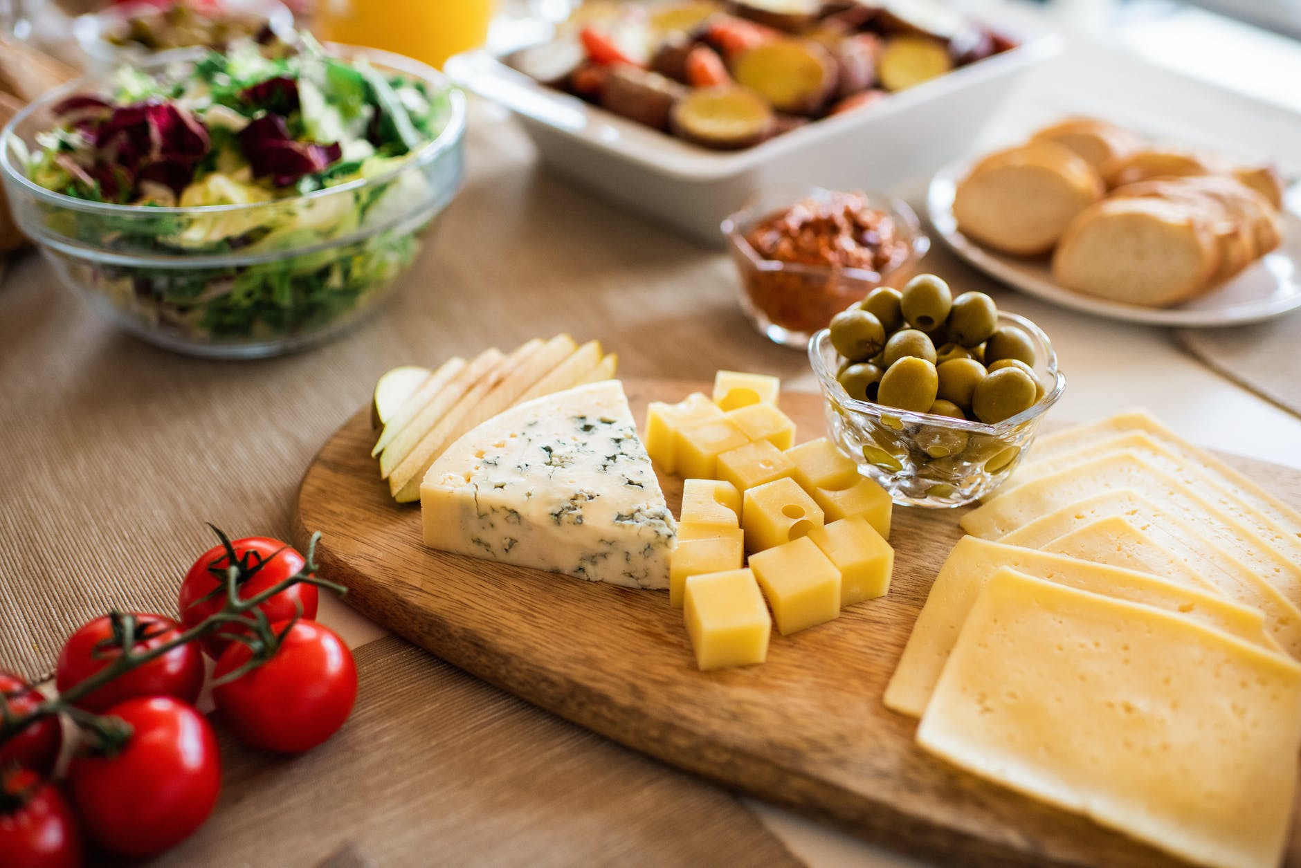 cheese and red tomato on brown wooden chopping board