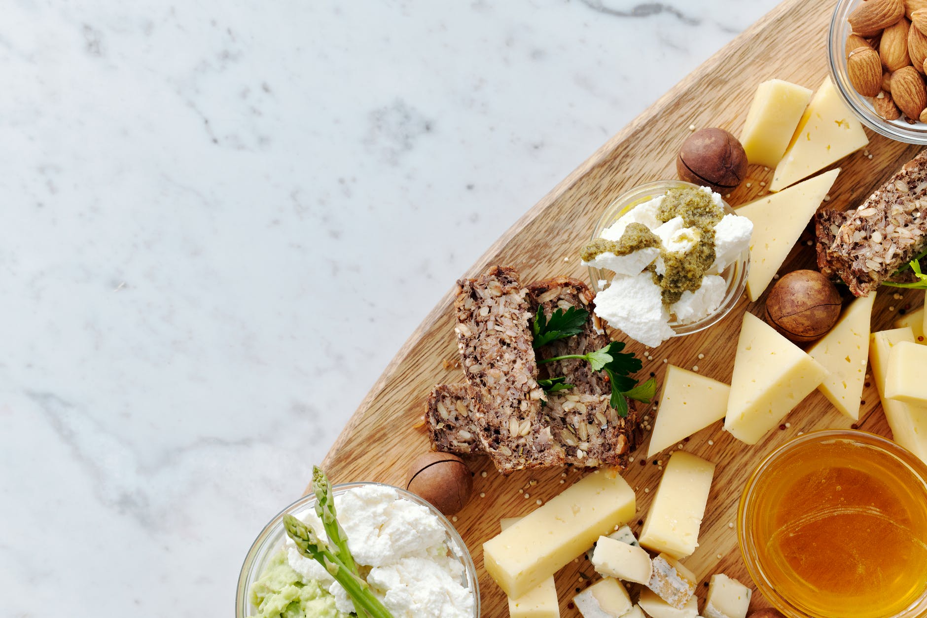 close up photo of sliced cheese on brown wooden chopping board